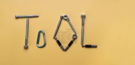 Photo for Sign Tool, frame with copy space made of bolts, screws. Banner on yellow plain background - Royalty Free Image