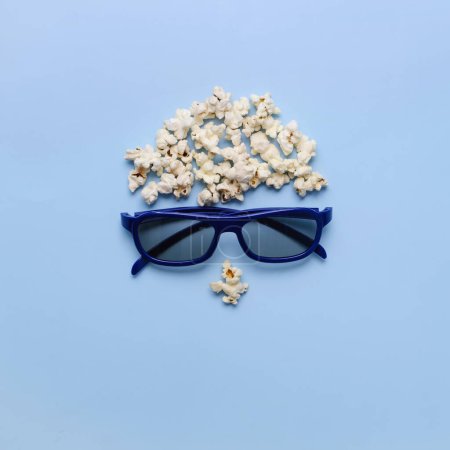 Photo for Pop Corn man face on blue background. Cinema concept. Top view flat lay with copy space. 3D eye glasses for romantic movie for couple. - Royalty Free Image