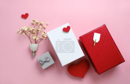 Photo for Valentines day gift idea, romantic creative flat lay card with copy space on pink. Small flowers in bulb shape. Little and big boxes, hard shape. Flat lay top view - Royalty Free Image
