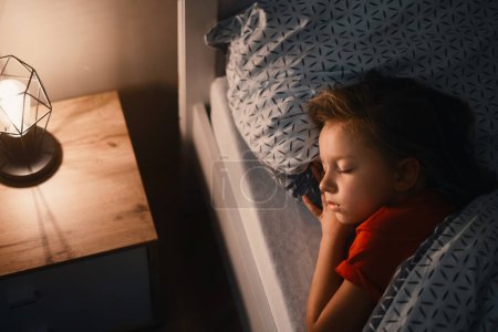 Photo for Child sleeping at night. Comfortable bed for kids. Toddler girl sleeping tight, fast falling asleep, healthy habits and comfortable bedding - Royalty Free Image