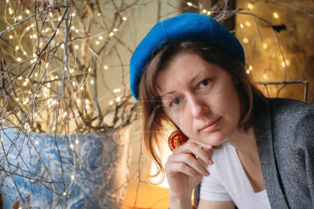 Photo for Creative young woman artist in atmospheric studio. Portrait of female in retro style. Authentic person with bright self-expression in beret - Royalty Free Image