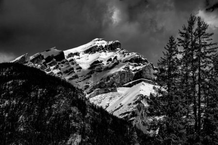 A mountain peak in the Canadian Rockies viewed from George Biggy Sr Road, Dead Mans Flats, Alberta. High quality photo