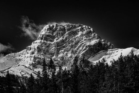 Snow covered peak in Canadian Rockies, on George Biggy Sr Road, Dead Mans Flats, Alberta, Canada. High quality photo