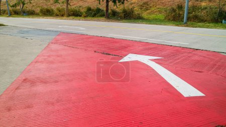 Photo for White paint arrow sign on parking ground points to highway - Royalty Free Image