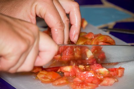 Cutting tomato during food preparation