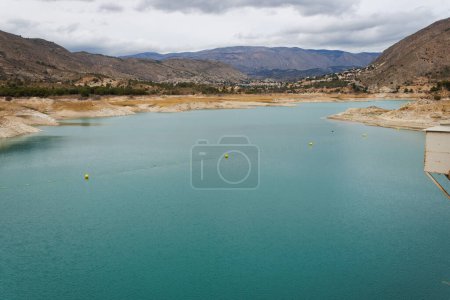 Photo for Landscape with the Amadorio Reservoir and low water level due to climate change. Orcheta, Spain - Royalty Free Image