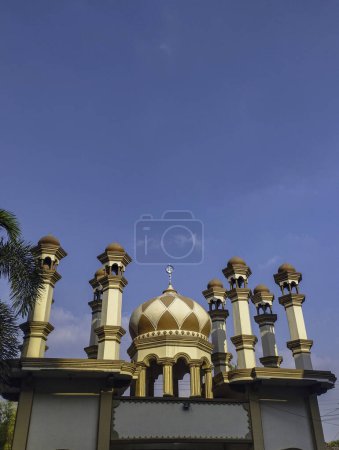 Foto de Las cúpulas y minaretes de una mezquita bajo un cielo azul claro. Imagen religiosa de fondo. - Imagen libre de derechos