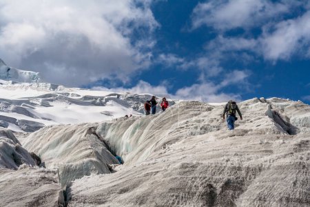 Photo for Sonwy Huaytapallana, Huancayo Peru: tourists walking on snow covered mountains in central Andes - Royalty Free Image