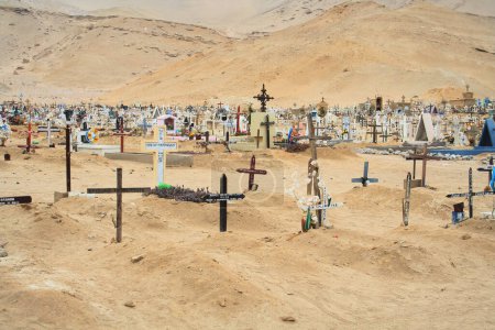 Photo for A view from a hill in the cemetery, in the mountains of the dead sea. the stones are covered with white stones and a cross. - Royalty Free Image