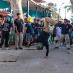 A group of breakdancers dance on a street in the Barranco district attracting many spectators. Lima Peru.