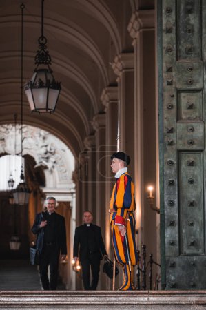Photo for Rome, Italy - May 18 2023: Swiss guard with historic dress guards Vatican Palace gate - Royalty Free Image
