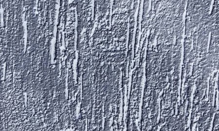 Abstract paint is peeling off the building wall.Close-up. Badly fixed building facade wall covered with cracks in stucco and paint. Missing patch of paint in the middle; crack with flappy.Wall texture with scratches and cracks.Seamless gray concrete.