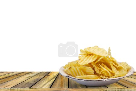 potato chips in bowl setting on wooden table on white background