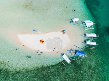 Photo for Drone view of boats on coastline of sandbar, turquoise water and colar reefs. Barobo, Surigao del Sur. Philippines. - Royalty Free Image