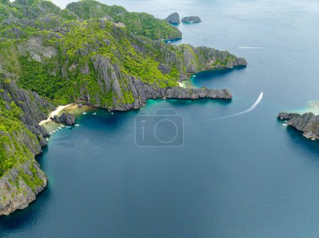 Top view of Miniloc Beach with boats over the blue sea. El Nido, Palawan. Philippines.
