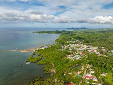Panorama view of Looc Poblacion with residential area and green forest. Tablas Island. Romblon, Philippines.