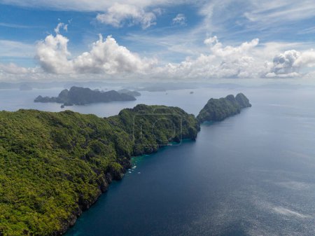 Tropical blue sea and Matinloc Island. El Nido, Philippines.