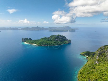 Helicopter Island surrounded by blue sea. Blue sky and clouds. El Nido, Palawan. Philippines.
