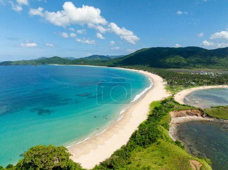 Clear turquoise water and sea waves on sands. Nacpan Beach. El Nido, Palawan. Philippines.