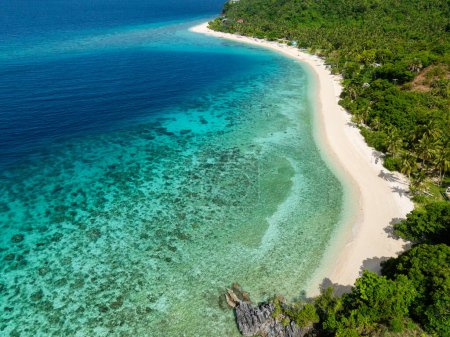 Top view of blue sea and turquoise sea water in sandy coastal area. Cobrador Island. Romblon, Philippines.
