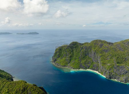 Islands with limestone rock structures in El Nido. Tapiutan and Matinloc. Palawan. Philippines.