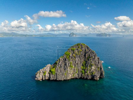 Twin Rocks surrounded by blue sea. Blue sky and clouds. El Nido, Palawan. Philippines.