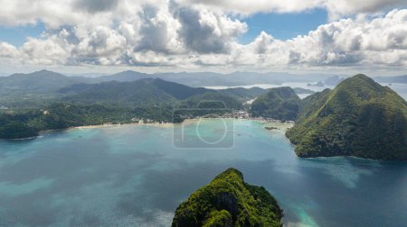 Top view of coastal town with boats floating over turquoise water. El Nido, Palawan. Philippines.