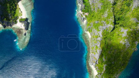 Coastline with sandy beaches and blue sea. Tapiutan and Matinloc. El Nido, Philippines.