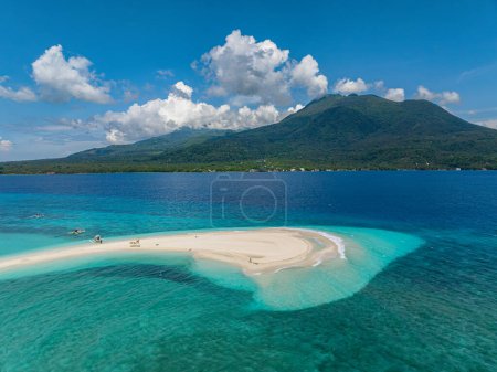 Drone view of white sandpit and boats in Camiguin Island. Clear water and waves. Philippines.