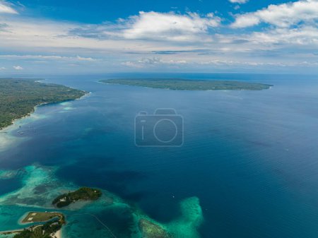 Blue sea and tropical island. Blue sky and clouds. Samal, Philippines.