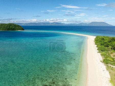 Bon Bon Beach with transparent sea water and waves. Blue sky and clouds. Romblon Island. Romblon, Philippines.