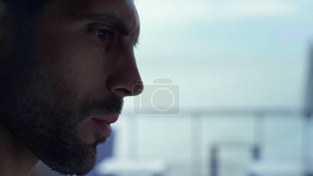 Photo for Profile of pensive man resting in stylish restaurant. Bearded hipster guy looking aside in panoramic cafe closeup. Attractive businessman enjoying lunch break. Thoughtful male face expression closeup - Royalty Free Image