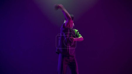 Photo for Concentrated person practicing fencing exercising using VR headset. Youngster man defending from enemies training at simulator competition game slow motion. Futuristic network experience concept - Royalty Free Image