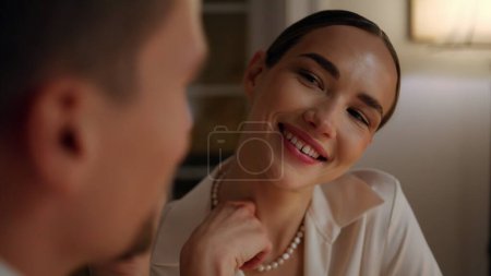 Photo for Coquettish girl enjoying romantic evening in restaurant portrait. Smiling lady flirting with unknown man at anniversary date closeup. Enamoured sweethearts celebrating holiday relaxing in night home - Royalty Free Image