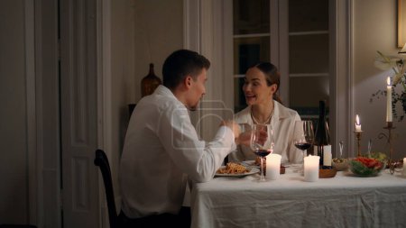 Photo for Positive lovers talking at candles table room closeup. Laughing newlyweds having fun at romantic date. Cheerful couple dining together at evening apartment. Happy pair enjoying at night place - Royalty Free Image