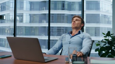 Photo for Closeup stressful boss calming down in office. Nervous businessman feeling angry after bad meeting. Depressed employee tired of work problems. Man meditating at workplace alone. Troubles concept - Royalty Free Image