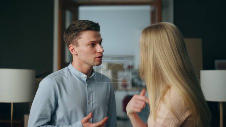 Photo for Angry couple discussing disagreement in unhappy relationship at home close up. Married young couple arguing feeling stress. Man woman taking offense on each other experiencing communication problem. - Royalty Free Image