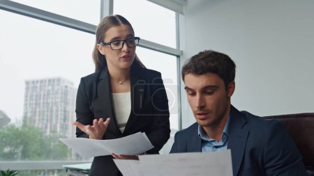 Photo for Confused manager talking boss explaining mistakes. Angry man throwing papers examining financial contract in office. Nervous upset bank worker report excusing for problems. Unsuccessful project work - Royalty Free Image