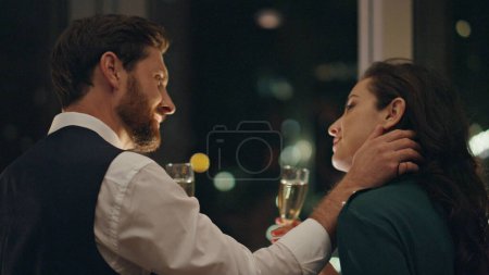 Photo for Couple lovers flirting on date drinking champagne at window closeup. Bearded man touching gently woman face seducing attractive girl. Two people in love enjoy romantic relationship relax late evening. - Royalty Free Image
