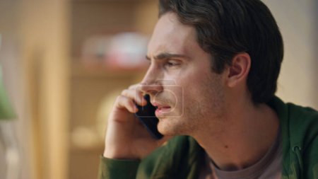 Photo for Cheerful freelancer phone call speaking at office closeup. Happy emotional man communicating smartphone enjoying conversation at creative workplace. Smiling young businessman talking alone in cabinet - Royalty Free Image