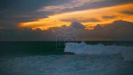 Photo for Dark ocean rolling dawn at amazing cloudy skyline. Beautiful sea surf crashing foaming before evening storm. Stunning dusk waves barreling seashore swelling shallow reef. Scenic pastel seascape nature - Royalty Free Image