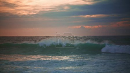 Photo for Waves rolling evening seascape before storm. Beautiful endless ocean in evening. Powerful sea surf splashing breaking shallow coast reef at gloomy dawn. Scenic marine landscape in super slow motion. - Royalty Free Image