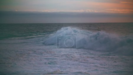 Photo for Huge sea wave foaming at morning skyline. Powerful surf rolling breaking shallow at dawn in super slow motion. Beautiful ocean swelling crashing in cloudy evening. Stunning endless seascape at dusk. - Royalty Free Image