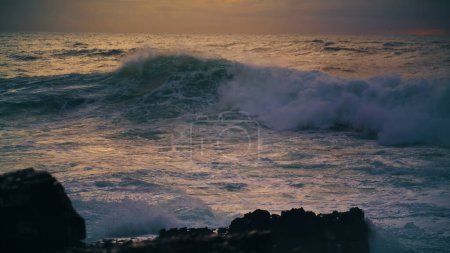 Photo for Sea waves breaking shallow reef in morning. Powerful surf barreling crash rocky coastline in evening slow motion. Beautiful white ocean water rolling washing volcano beach. Stunning shore view at dusk - Royalty Free Image