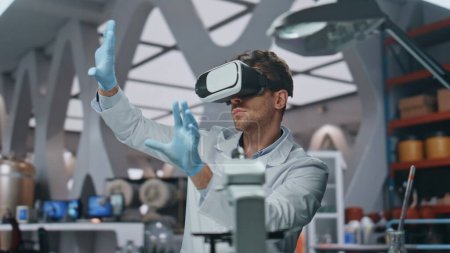 Vr glasses chemist working with futuristic simulation in advanced laboratory close up. Serious scientist using virtual reality headset for scientific research. Lab bioengineer touching interface.