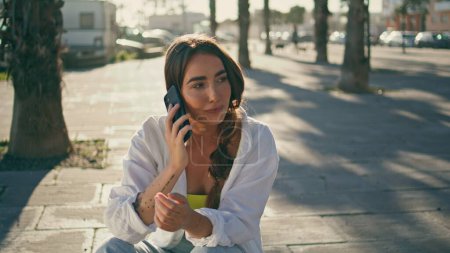 Positive girl calling phone at sunny day exterior close up. Millennial lady talking smartphone reacting at jokes outdoors. Smiling hipster woman telling funny story at cellphone chat showing emotions 