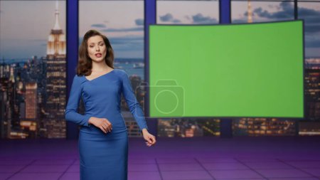 Photo for Charismatic anchorwoman talking at green screen tv studio. Elegant smiling woman presenter lighting breaking news on television channel. Beautiful female newsreader reporting daily events on mockup. - Royalty Free Image