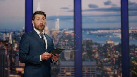 Photo for Elegant newscaster presenting daily breaking news in evening television show close up. Bearded professional presenter beginning broadcasting newscast. Confident man host reporting about business event - Royalty Free Image