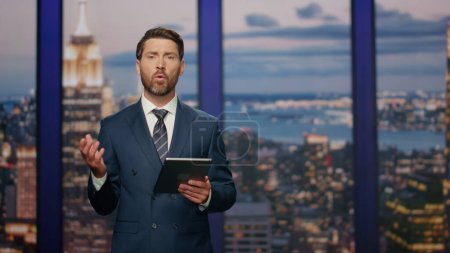 Photo for Bearded anchor man talking at newscast modern multimedia channel close up. Confident man newsreader covering daily news in television studio. Serious newscaster reporting business information in air. - Royalty Free Image