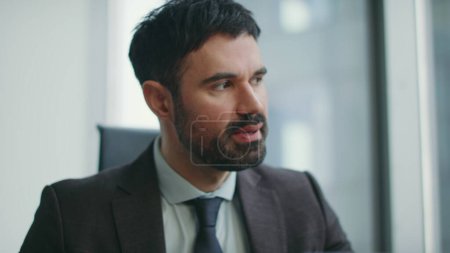 Frustrated boss feeling anger for work mistake sitting company office close up. Furious bearded businessman reacting emotionally at business crisis indoors. Stressed investor worried about profit loss
